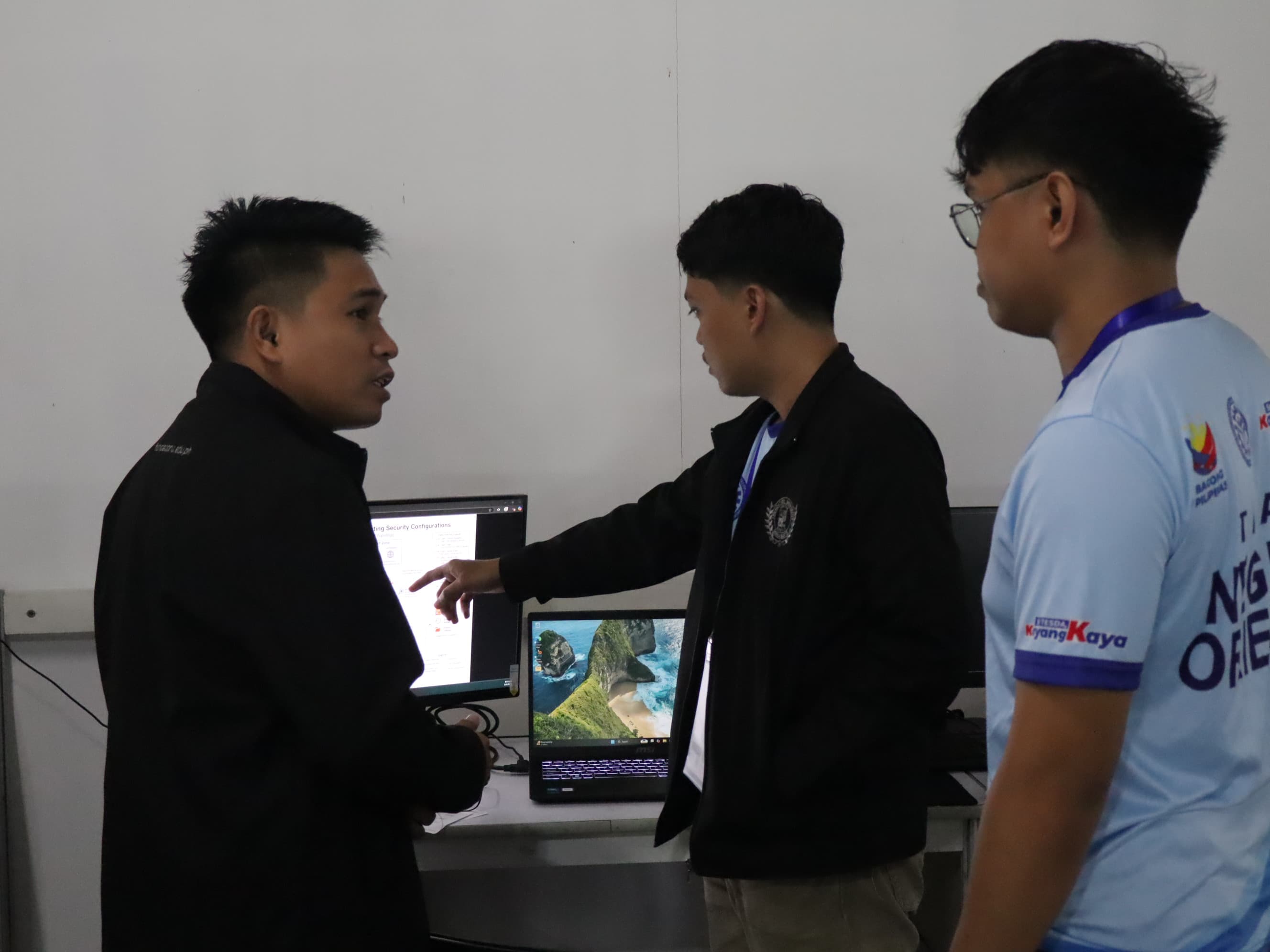 Competitors and expert discussing a cybersecurity task